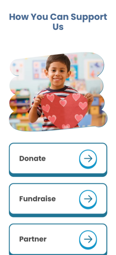 In a bustling classroom, a boy holds up a heart-shaped cutout adorned with heart patterns. Above him, the message How You Can Support Us shines. As a not-for-profit initiative, we invite you to Donate, Fundraise, or Partner through buttons featuring arrow icons.